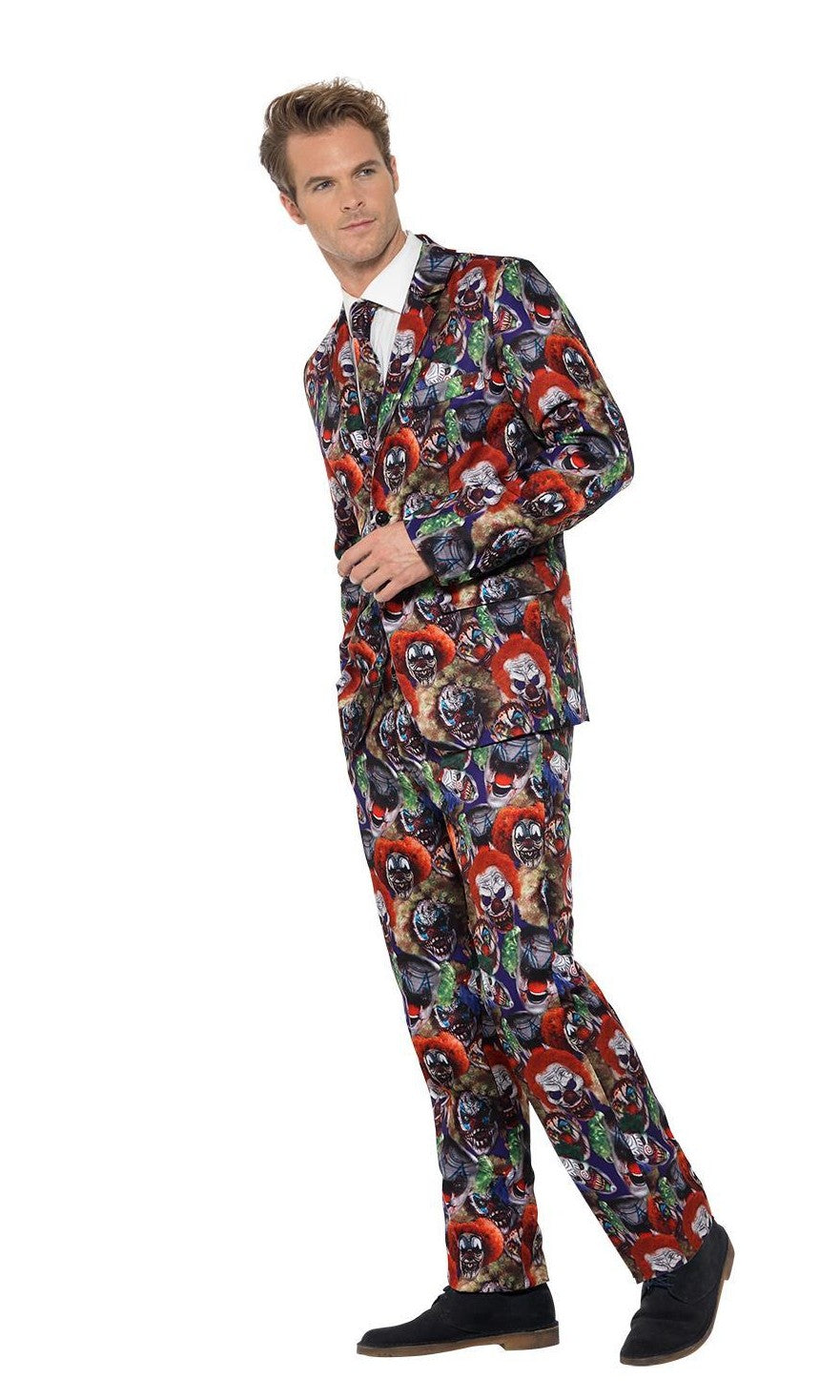 Side view of a man wearing a colorful suit with a pattern of scary clown faces on a white background