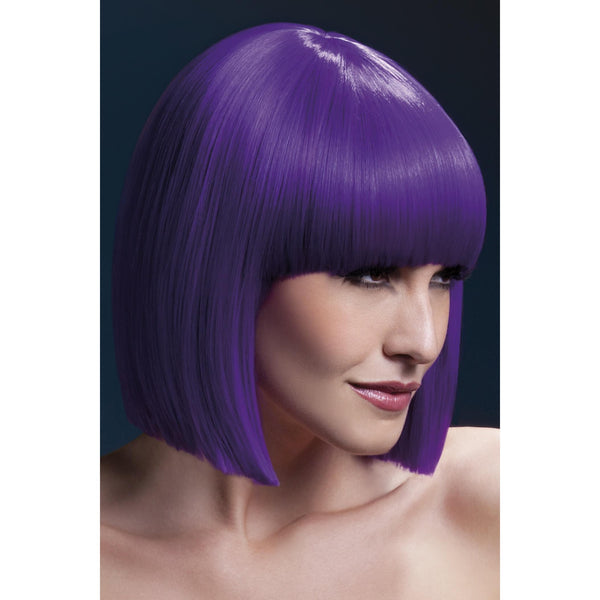 Woman wearing a vibrant purple wig against a dark background