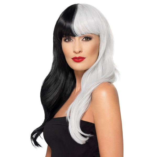 Woman wearing a long black and white half wig on a white background