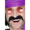A man wearing a black self-adhesive tash, also known as a mustache, paired with a purple bandana and orange round glasses.