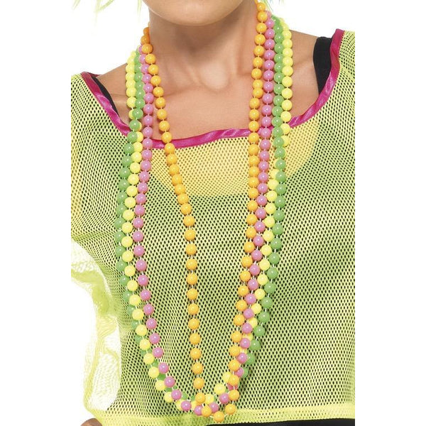 Four strings of neon pearls worn by a female in a 1990s style top neon green mesh top
