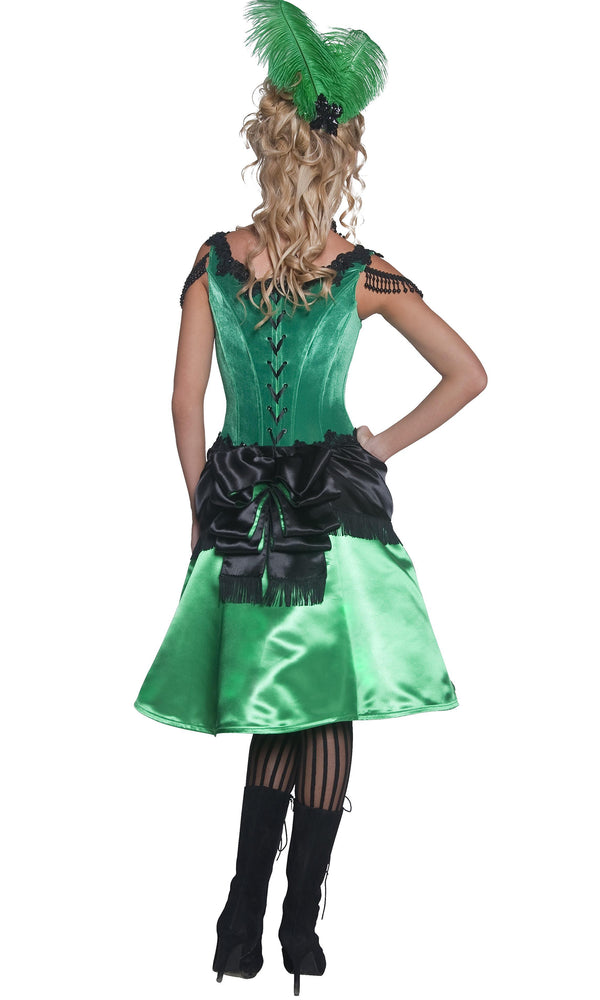 Back view of a model wearing a green and black western saloon girl costume with a corset top and attached petticoat, wearing black stockings.