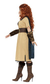 Side view of a woman modeling a Scottish warrior costume with a beige dress, blue cape and arm cuffs.
