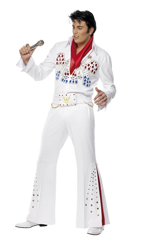 A man wearing a white Elvis costume with a jewelled eagle pattern, belt, red scarf and flared pants