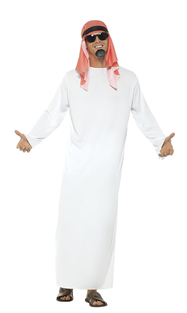 A man wearing a white tunic and a headpiece with a red and white headdress, resembling an Arabian costume
