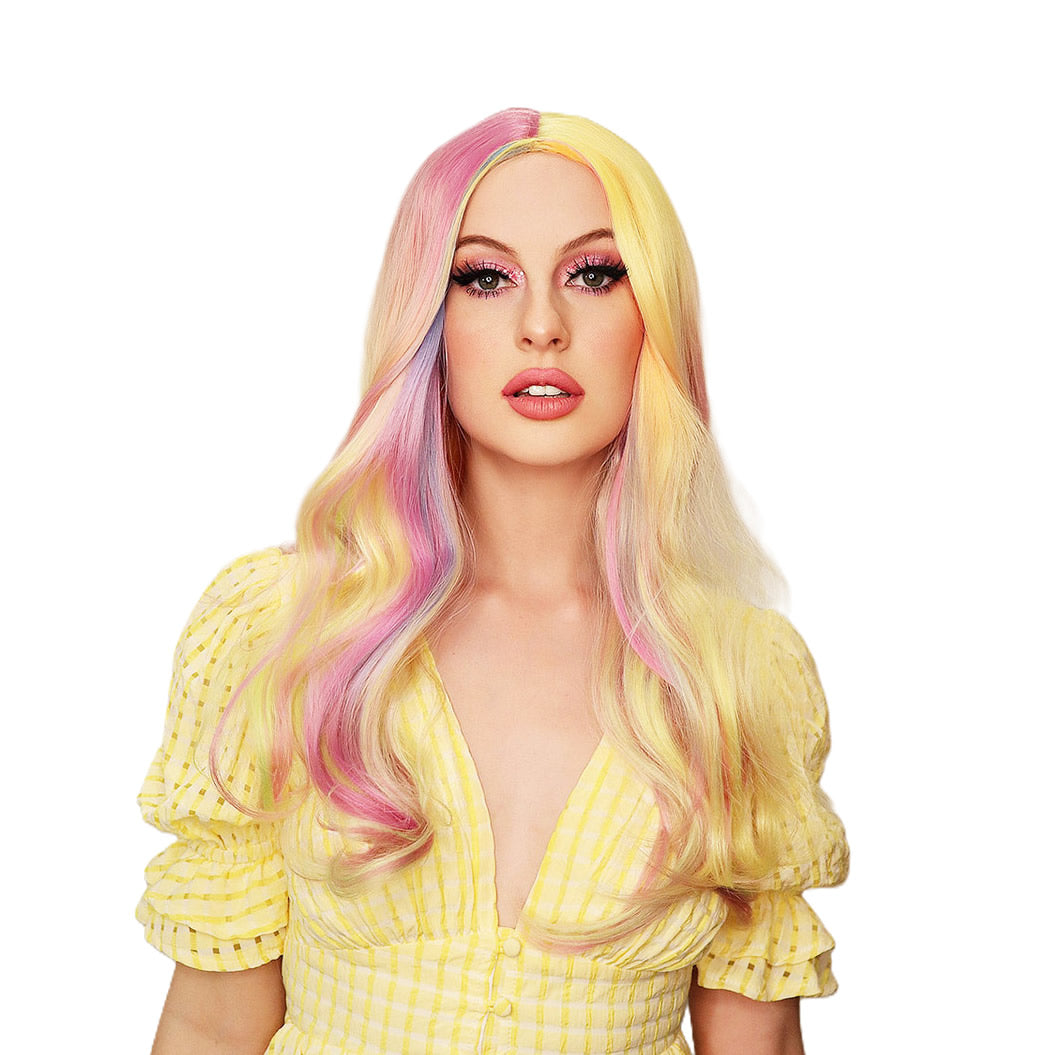 Woman with a long colorful wig and yellow dress on a white background