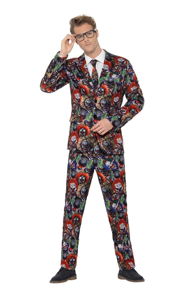 Man wearing a colorful suit with a pattern of scary clown faces on a white background