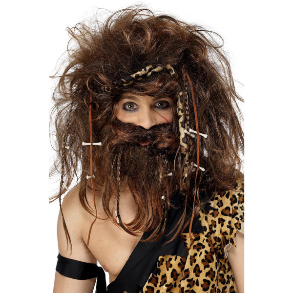 Person wearing a caveman costume with wig, beard on a white background