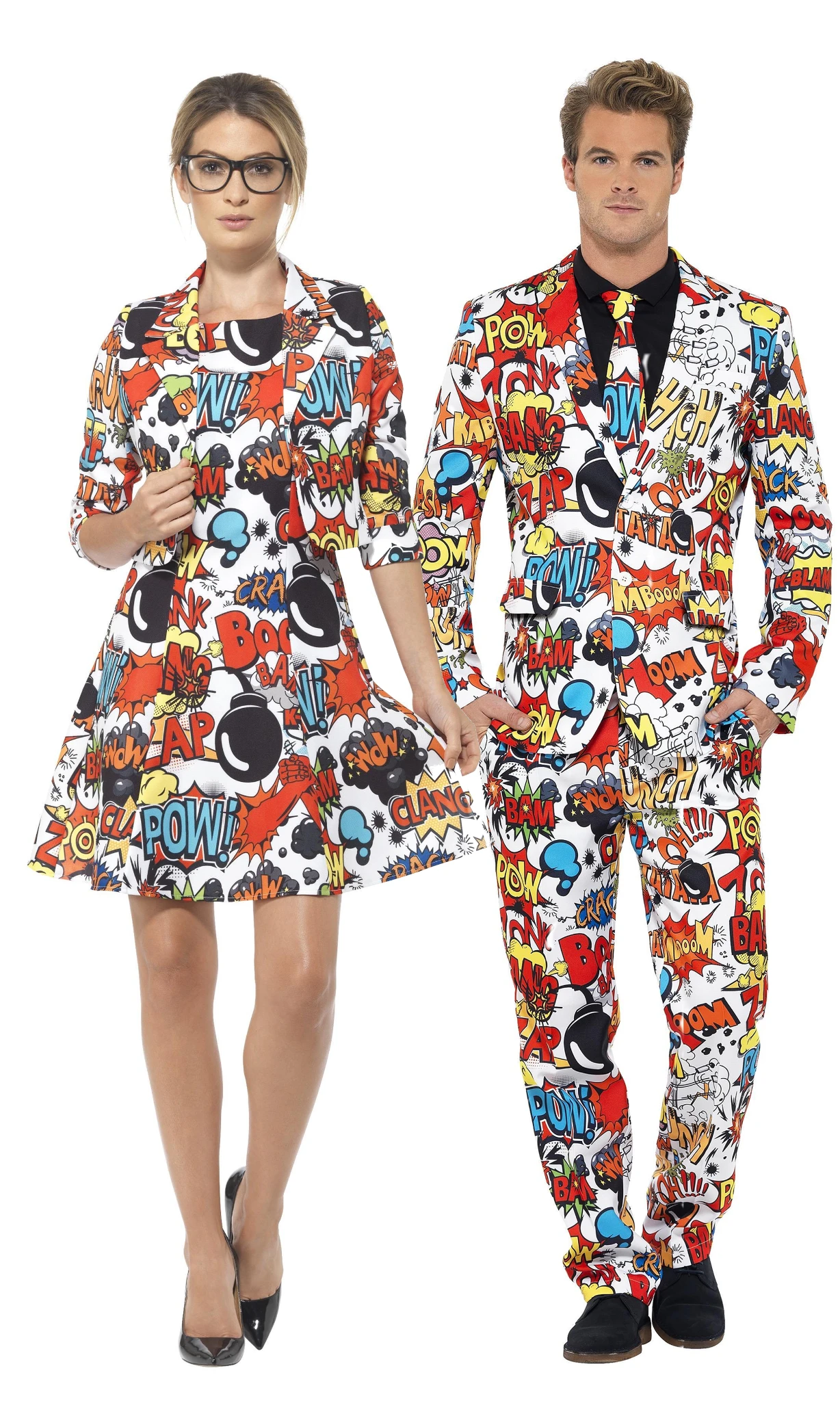 A man and a woman modeling matching comic-book style costumes. The woman wears a short white dress with a colorful pop-art print, and the man wears a matching suit with the same print over a black shirt and tie.