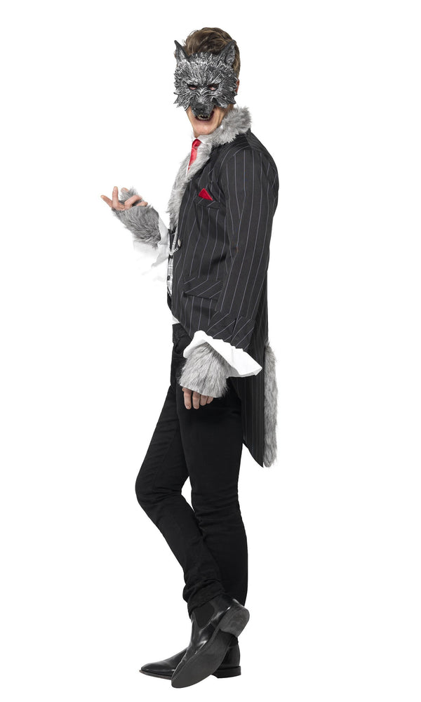 Side view of a man wearing a wolf costume with a suit and mask