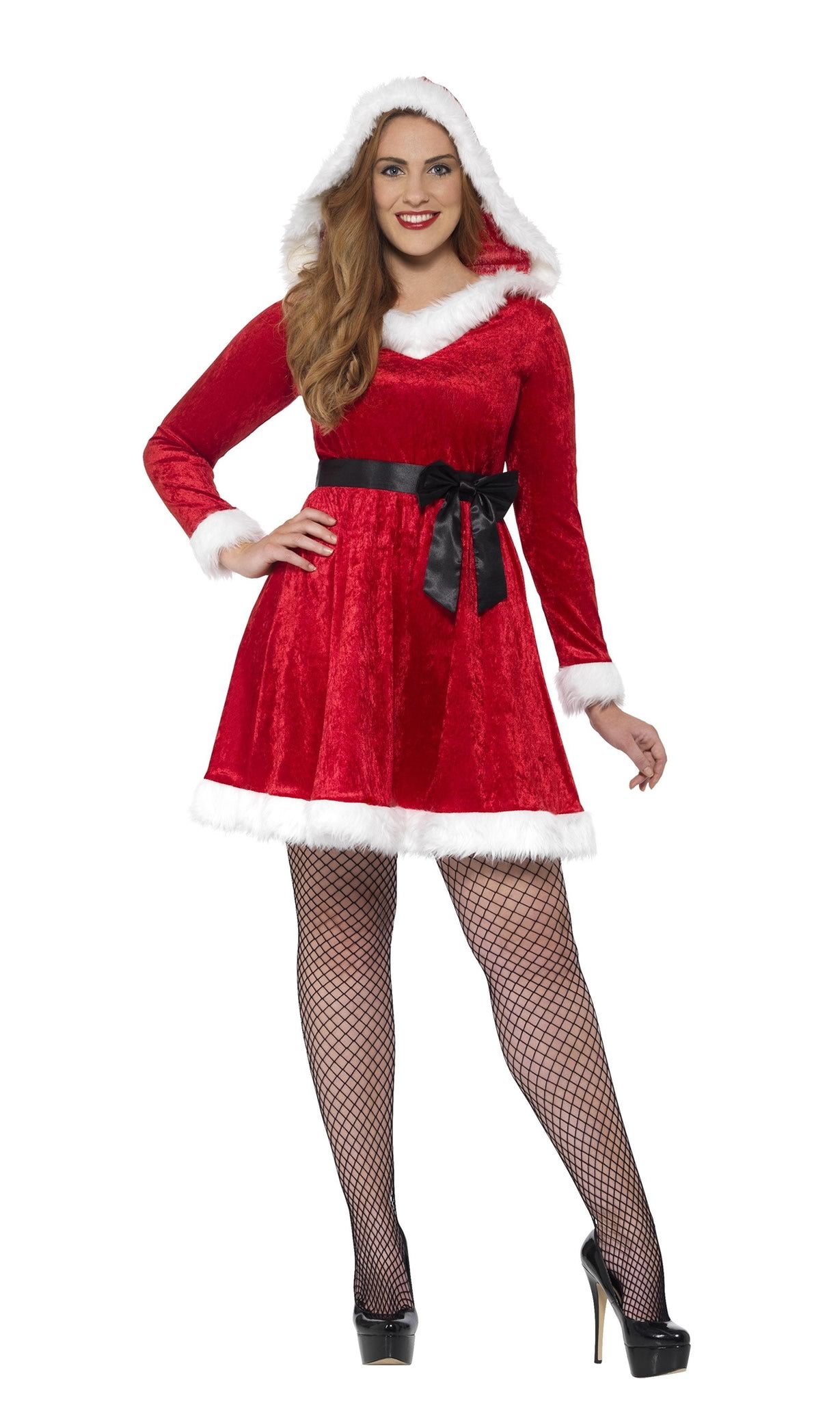 Woman wearing a red Santa Claus costume with white trim and fishnet stockings