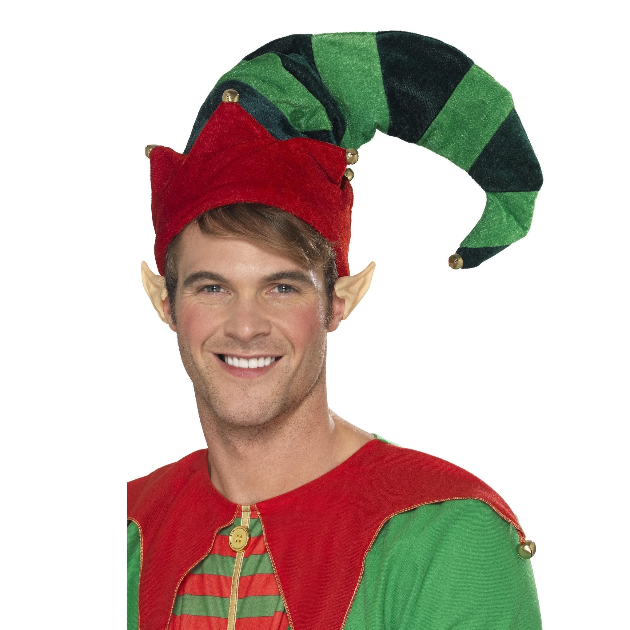 Man wearing a red and green elf costume with a pointed hat on a white background