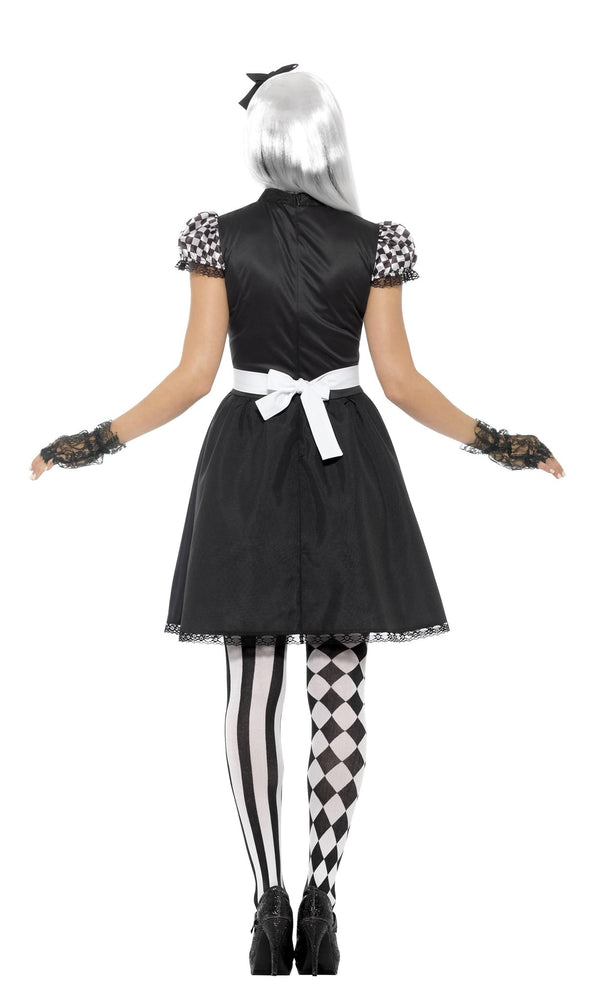 Back of a woman wearing a black and white maid costume with checkered stockings on a white background