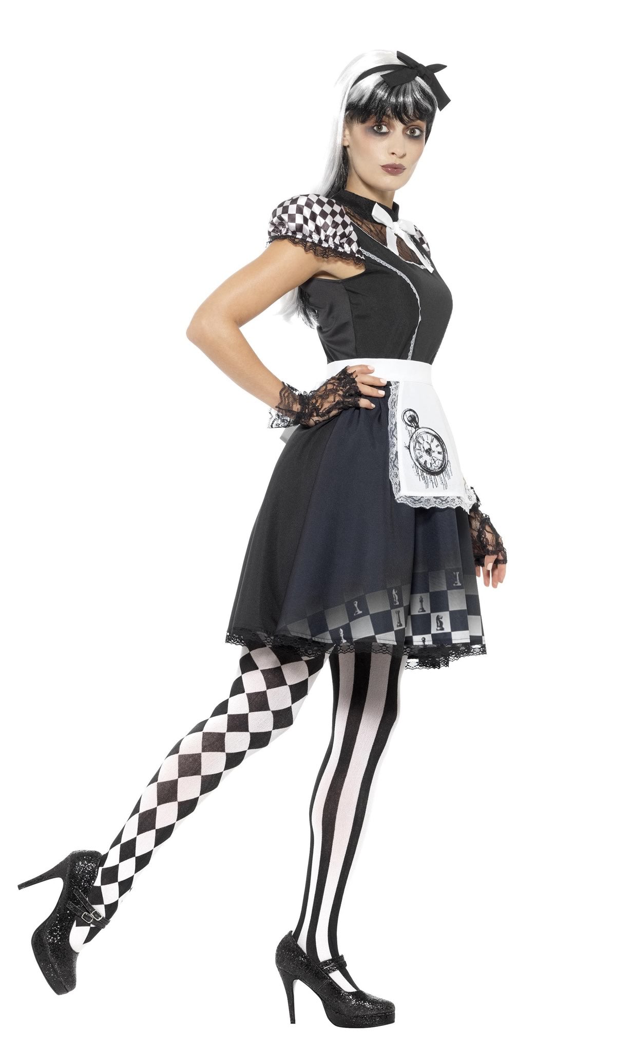 Side of a woman wearing a black and white maid costume with checkered stockings on a white background