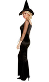 Side view of a woman wearing a black witch costume with a hat on a white background