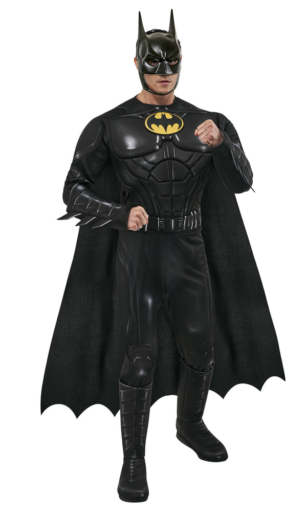 A man wearing a detailed Batman costume with cape and mask