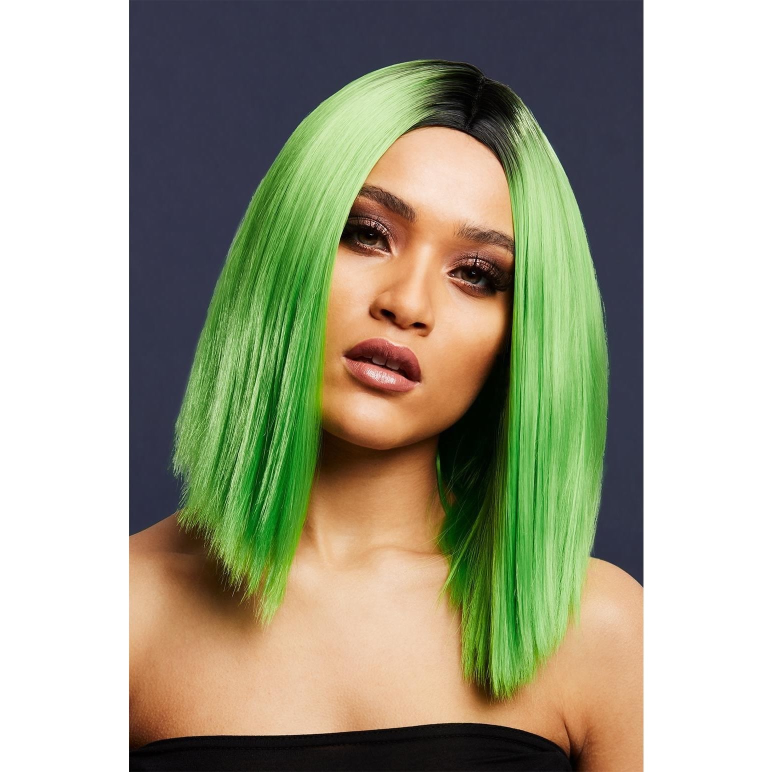 Woman with a vibrant green wig against a dark background
