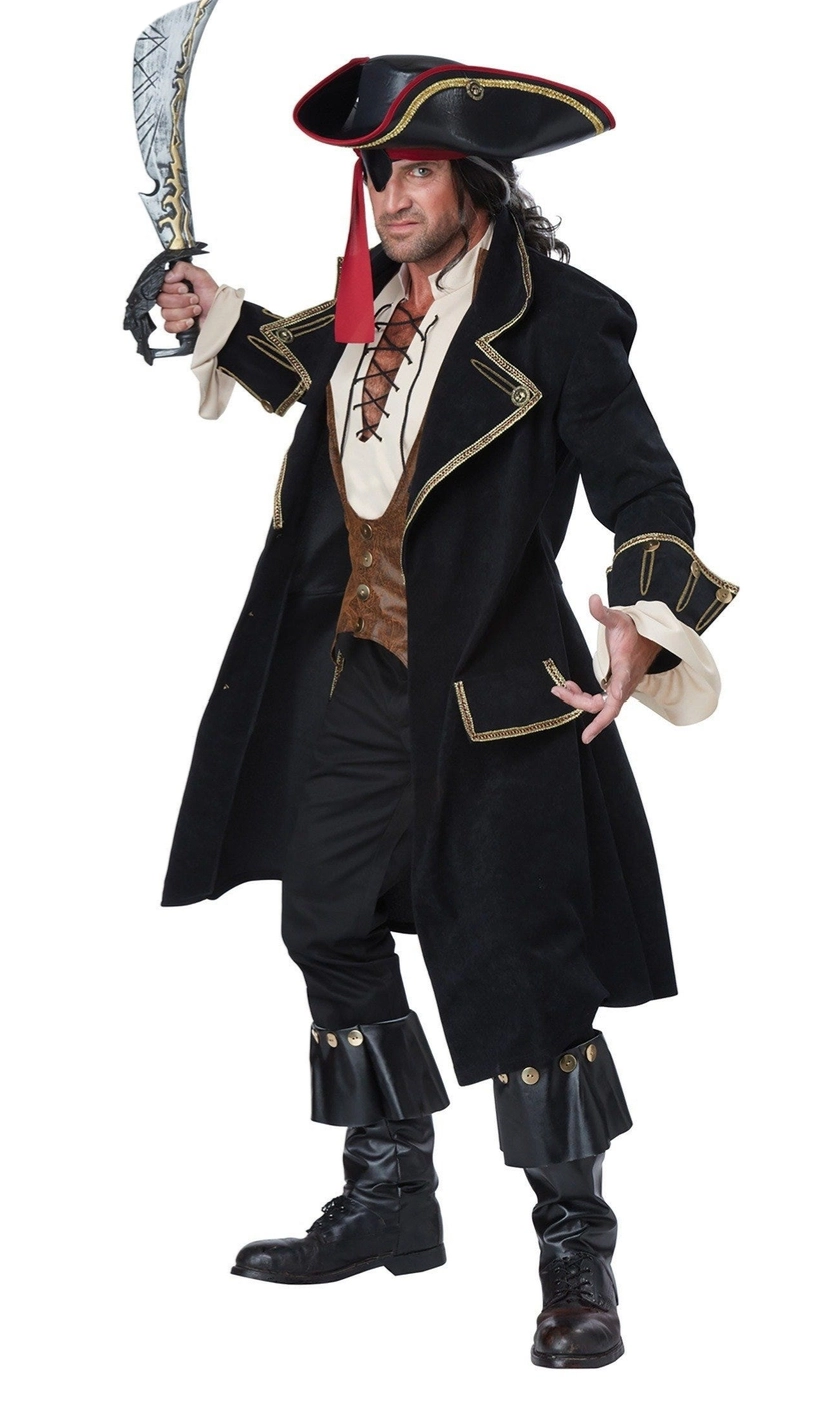 A man modeling a pirate costume, holding a toy sword. The costume includes a black tricorn hat with red and gold trim, a long black coat with gold trim, a brown vest, a cream shirt, and black pants and boots.