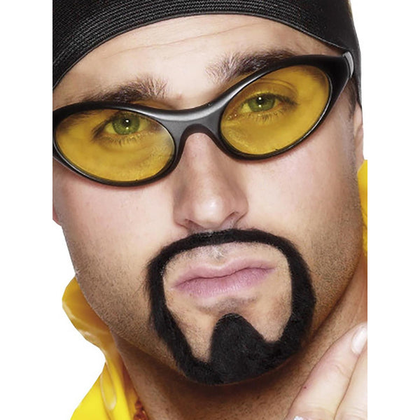 Close-up of a person wearing yellow sunglasses with a black frame looking like Ali G