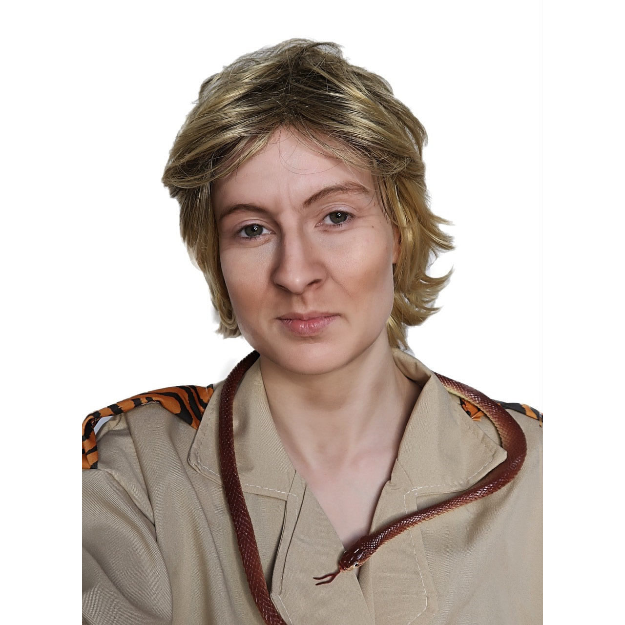 Person wearing a Steve Irwin style wig and a beige safari uniform with a snake