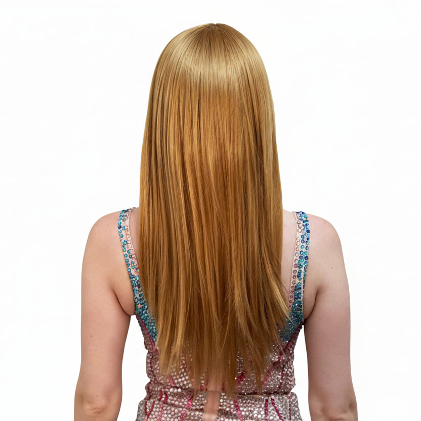 Back of a woman with a long copper blonde wig and red lipstick wearing a sequined dress