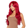 A woman modeling a long, vibrant red wig with voluminous curls and a side-swept bang.