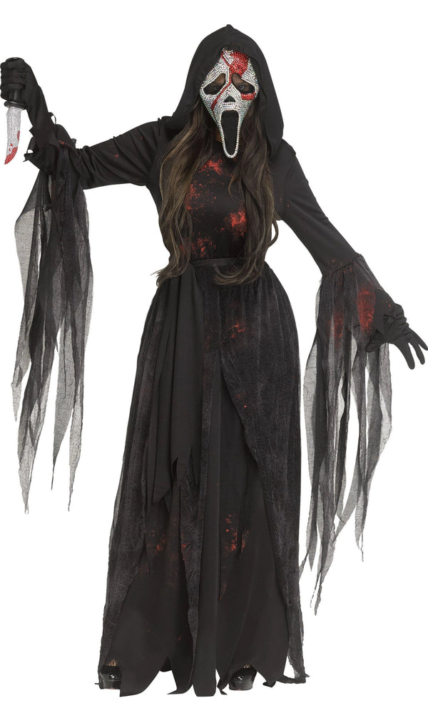 A person modeling a Ghostface-style Halloween costume. The costume includes a long black hooded robe with tattered sleeves and hem, a white mask with red blood-like splatter and an open mouth, long dark hair, black gloves, and a knife prop in one hand.
