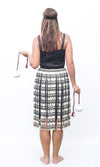Back of a woman wearing a Kiwiana Maori Kapa Haka dress, poi and headband.