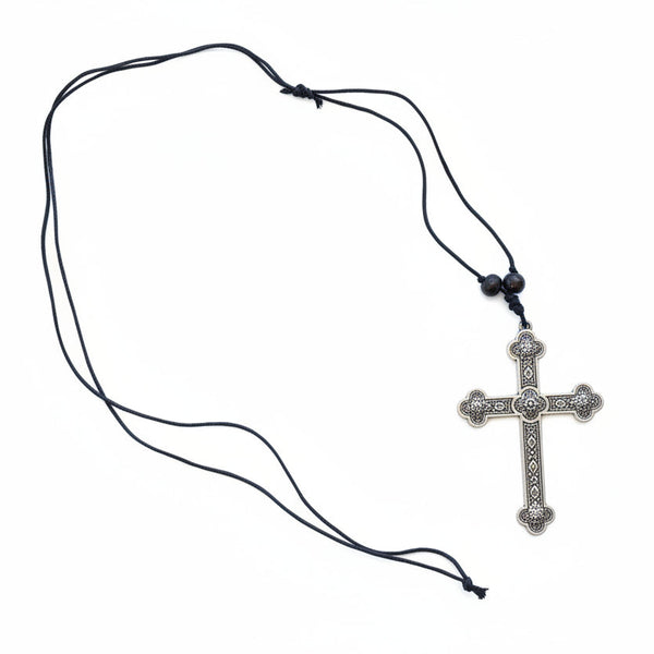 Silver cross pendant on a black cord