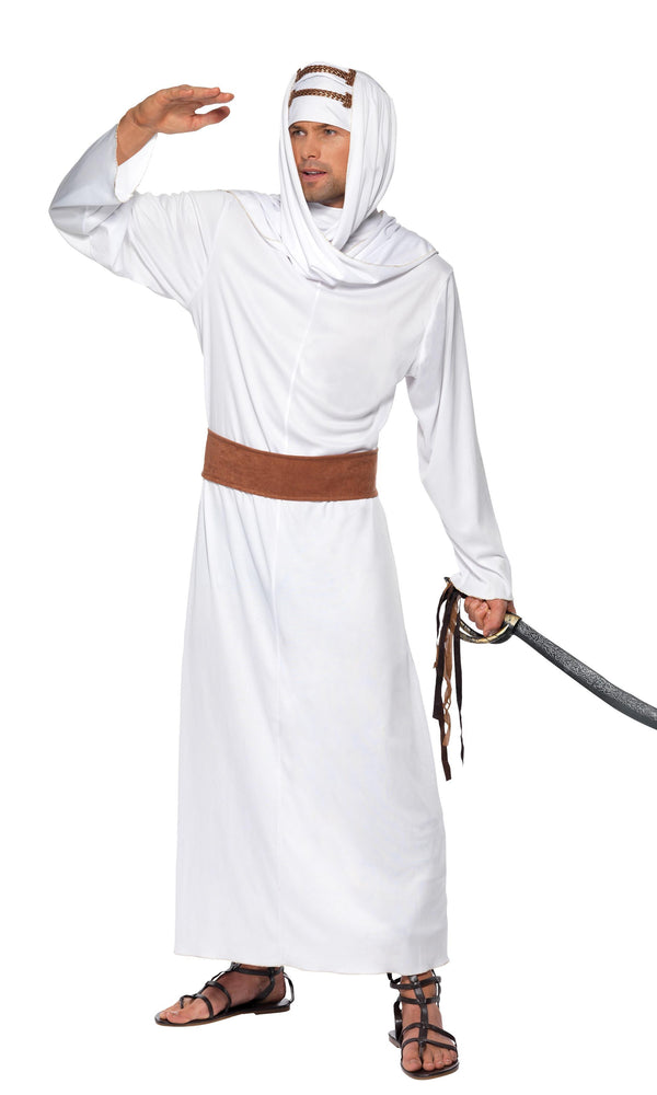 A man wearing a white Arabian costume with a belt and headpiece, holding a sword, suitable for portraying T. E. Lawrence.