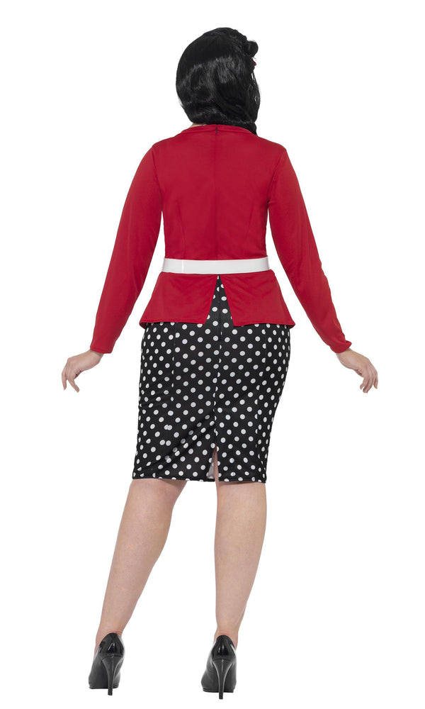 Back of 50s plus size black and white spotted dress with mock red cardigan, flower pin hairclip and belt