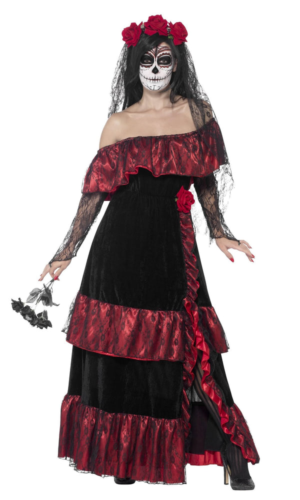 Woman wearing a black and red dress with floral headpiece on a white background