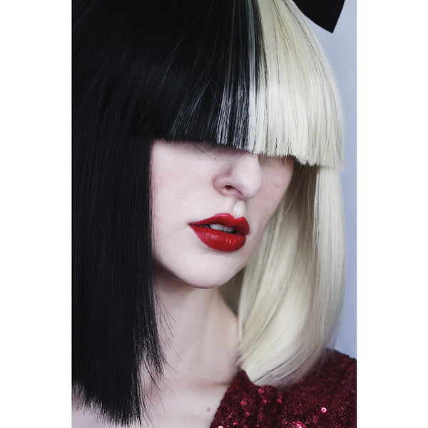 Side view of two sided black and blond Sia wig with black bow