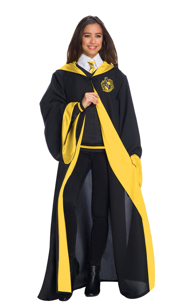 Woman wearing yellow and black Hufflepuff robe with sweater and tie