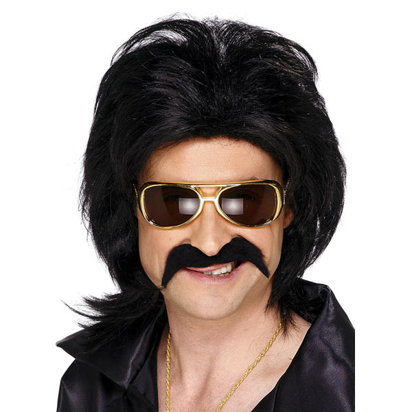 A man wearing a black self-adhesive tash, also known as a mustache, paired with a wig and sunglasses to complete a costume.