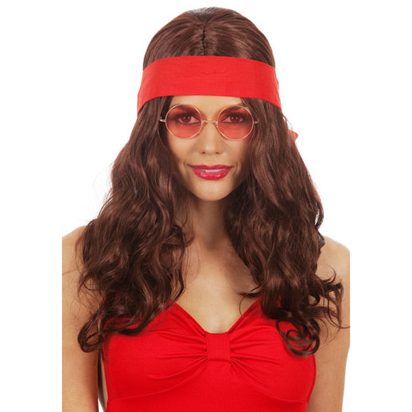 Long brown unisex 60s hippy wig with red headband worn by a woman