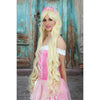 A woman wearing a deluxe blond wig with a princess-style crown, dressed in a pink outfit.