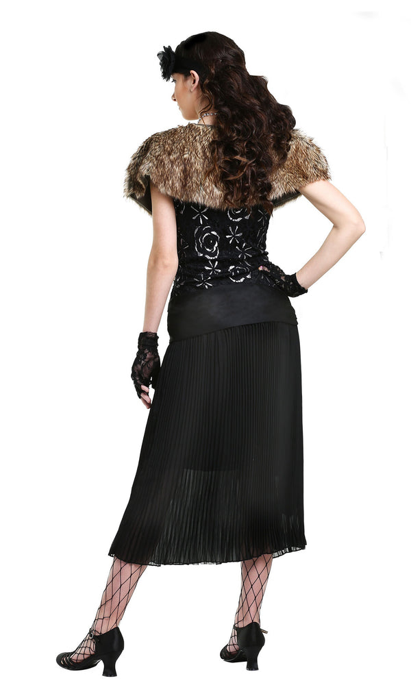 Back of long black flapper dress with silver pattern, fur capelet, black flower headband and gloves
